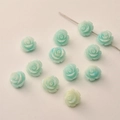 Close-up of 12mm mint green resin rose beads with central hole for DIY jewelry making - Light Blue Two-Tone
