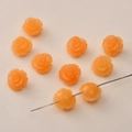 Macro detail of 12mm orange resin rose beads with pre-drilled holes for DIY jewelry - Agate Yellow Two-Tone