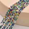 Close-up of 2mm cube glass beads in multiple colors for DIY jewelry making - Blue Green Mix