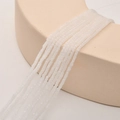 Macro detail of 2mm square white translucent crystal glass beads for DIY jewelry making - White Jade