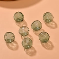 Macro detail of dark green faceted glass hollow beads with precision cut for DIY jewelry - 1 Piece / Lake Green