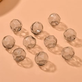Ten faceted grey transparent hollow glass beads for DIY jewelry making on orange background - 1 Piece / Gray