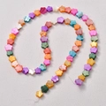 Macro detail of colorful floral shell beads with pearlescent finish for jewelry DIY - Medium Size / Flower Style