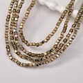 Macro detail of multi-layered 3mm gold faceted hematite cubes for DIY jewelry making - Antique Gold Cube