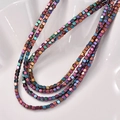 Macro shot of 3mm rainbow metallic hematite cube beads for DIY jewelry making - Colorful Squares
