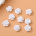 Flat lay of nine white 12mm resin rosebuds for DIY earring and hair accessory making - White