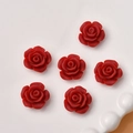 Detail shot of six red resin rose flower charms for DIY jewelry making on white plate - Dark Red