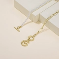 Golden OT buckle necklace with bamboo-textured letter G pendant and pearl strand - Letter G