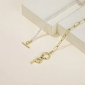 Elegant gold paperclip chain and white pearl necklace featuring a metallic letter P - Letter P