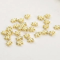 Macro view of 4mm gold plated snowflake spacers with cubic zirconia for DIY jewelry - 14K Gold Plated Snowflake Zirconia