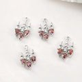Close-up of four silver vintage chandelier pendants with red teardrop stones for DIY jewelry - White Gold Red Zircon Chandelier Style