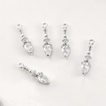 Macro shot of silver teardrop pendant charms with clear zircon stones for DIY jewelry - White Gold White Zircon Small Lamp Style