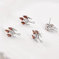 Macro detail of silver plated earring findings with triple red pear-shaped zircons - White Gold Red Zirconia Crystal Light (19.5x11.5mm)
