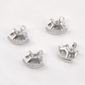 Detailed view of four silver plated rocking horse pendants with sparkling zircon stones - White K Smooth Trojan Horse