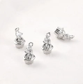 Detail of four silver cupcake charms with zircon hearts and bow accents for DIY jewelry - White K White Zircon Heart Cake