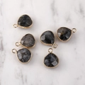 Macro detail of faceted grey stone pendants with gold metal edging for DIY jewelry making - Gold Edged Black Flash Stone