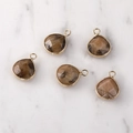 Macro detail of teardrop gemstone pendants with faceted brown texture and gold metal frame - Gold Edged Gold Sand Moonstone