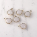 Detailed view of faceted drop-shaped crystal pendants with gold edges for jewelry DIY - Gold Edged White Agate