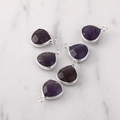 Detailed view of five faceted purple teardrop pendants with silver-edged metal frames - Silver Edged Amethyst
