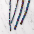 Detailed view of iridescent square hematite beads showing metallic oil slick finish - 4mm (100 Beads/Strand) / Rainbow