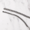 Close-up of polished gunmetal gray square hematite beads for DIY jewelry making - Antique Silver