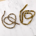 Detailed macro of square gold hematite spacer beads for DIY jewelry making projects - 4mm (100 Beads/Strand) / Antique Gold