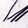 Macro shot of square colorful hematite beads with metallic luster for DIY jewelry making - Purple