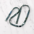 Macro shot of colorful iridescent square hematite beads for DIY jewelry making - Green