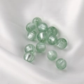 Close-up of light green translucent glass beads on white satin for jewelry making - Round Beads / 5 Pieces / 14# Light Green