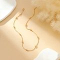 Elegant gold bead chain necklace with adjustable clasp shown on a warm aesthetic setting - Round Bead Gold Necklace (N2849-GO)