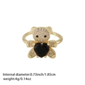 Gold bear ring with sparkling zircons holding a black heart gemstone on white background - Black Heart Gem Bear (Style 12)