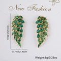 Golden earrings with emerald green zircon wings, sizing 3.49cm long and 8g weight - Green