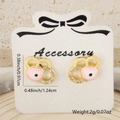Detailed view of gold plated evil eye stud earrings with pink zircon on display card - Hollow Heart Pink Eye Style (Style 1)