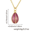Macro shot of egg-shaped pendant with gold honeycomb texture and magenta enamel detail - Pendant with Chain / Rose Red (Style E)