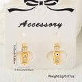 Gold plated huggie hoops with orange evil eye enamel and micro-pave zircons - Orange Yellow Style