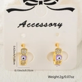 Golden Evil Eye hoop earrings with purple enamel and zircon inlay on display - Purple Style