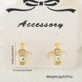 Gold huggie earrings with green enamel evil eye charm and clear zircon accents - Light Green Style