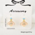 Pink enamel evil eye earrings in gold finish with sparkling zircon and blue bead detail - Pink Enamel Style