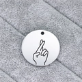Close-up of a round stainless steel pendant featuring an engraved sign language gesture - Good Luck Crossed Gesture (AL344)