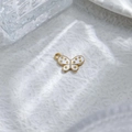 Detailed macro of gold butterfly pendant with white enamel inlay and circular loop attachment - Butterfly White Enamel Polka Dot Pendant (TZ-TP1009-02-white)