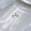 Golden bow pendant with white enamel filling for DIY jewelry making on textured background - White Enamel Bowknot Pendant (TZ-TP1006-02-white)