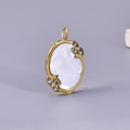 Oval stainless steel shell pendant with 18K gold finish and leaf-shaped stone accents - Pendant / Gold