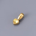 Macro shot of heart-shaped gold pendant with yellow zircon in polished bezel setting - November
