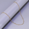 Detail van 18k vergulde roestvrijstalen slangenketting met elegante kleine kraalaccenten - L206-Zijkralenketting