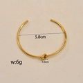 Golden knot open bangle bracelet with 5.8cm inner diameter in polished stainless steel - Knotted Open Bangle