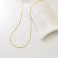 Detail of adjustable gold snake chain necklace with smooth polished metallic finish - Round Snake Chain