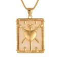 Macro view of a gold tarot card necklace featuring a heart and swords relief on white base - Three Swords Heart (D247-B)
