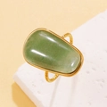 Vintage stainless steel ring featuring a large polished natural green stone with gold band - Green Aventurine