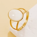 Vintage style gold open ring featuring a large oval white resin stone and double band - White