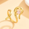 Geometrische gouden roestvrijstalen ring met roze zirkoon op warme roze achtergrond - Goud met roze zirkonia